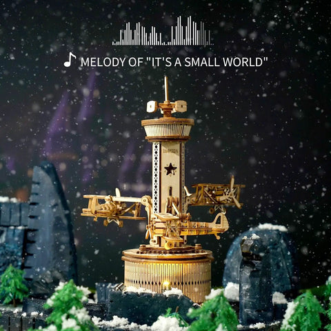 3D Wooden Puzzle Mechanical Music Box Aircraft Model Kit with tower, displaying exposed gears, snow effect background
