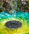 1.4W Solar Bird Bath Fountain Pump with upgraded panels, installed in a garden, spraying water into a colorful bird bath