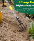 Heavy Duty Garden Hand Tiller Cultivator with four tines and adjustable long handle, loosening soil in a vegetable garden.
