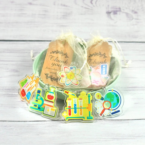 Science Party Favors 12 Pack Keychains With Thank You Kraft Tags And Organza Bags For Scientist Theme Birthday Party, Classroom Rewards, School Event Supplies, Easy Gift Set For Guests displayed in a bowl.