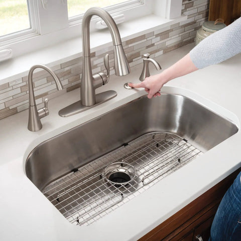 Removable Garbage Disposal Splash Guard And Sink Stopper, Tool Free Installation, reduces splashing in a stainless steel sink.