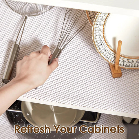 Top Shelf Nonslip Shelf Liner For Kitchen Cabinets And Drawers, White Non Adhesive Mat, 12 X 120 Inches with kitchen tools and plates.