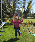 Child playing on 2 Pack Heavy Duty Kids Swing Seat Set With 66 Inch Chain Plastic Coated For Outdoor Playground Replacement Includes Safety Snap Hooks And EVA Seats That Supports Up To 250 Lbs Backyard Ready