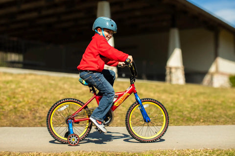 Child riding Red 18 Inch Kids Bike for Learning to Ride, Built to Last, Sturdy and Durable Frame in a park setting