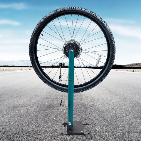 Professional Bicycle Wheel Truing Stand Removable Multifunction Wheel Alignment Tool Fits 16 To 29 Inch Mountain Bikes And 700c Road Bikes For Rim Calibration And Maintenance with a wheel on an outdoor road