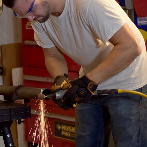 Man using Tough As Nails Straight Pneumatic Die Grinder at 25000 RPM for deburring task with sparks flying.