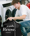 Person using Heavy Duty Nylon Laundry Bag With Locking Drawstring, Large 30x40 Inch Capacity, in front of washing machine