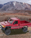 Red Toyota 1/12 Scale RC Rock Crawler Pickup Truck With 2.4GHz 4WD Off Road Remote Control on rocky terrain