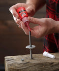 Person applying Perma Lock High Strength Threadlocker Red 36 Ml For Heavy Duty Bolts And Fasteners on a metal bolt