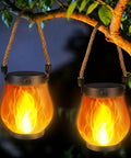 Ultra Real Flame Solar Lanterns Outdoor Waterproof 2 Pack With Dual Charging Modes Solar And USB Warm White Glow hanging on tree