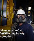 Worker wearing Rugged Comfort Quick Latch Half Facepiece Reusable Respirator 6501QL with silicone seal on industrial site.