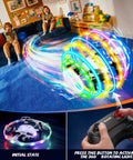 360 Degree RGB Light Rotation Kids Drone With Altitude Hold seen flying in a living room, controlled with handheld remote.