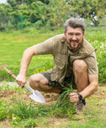 Gardener using Perennial Spade Trowel 21.6 Inch Long With Sharp Stainless Steel Blade And Wooden Handle for weeding in garden