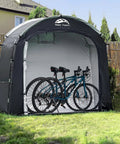 All Weather Outdoor Bike Storage Shed Tent Waterproof Portable Bicycle Cover with bikes inside, setup in a garden.