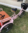 Hassle Free Fold Tandem Tricycle For Adults And Seniors With Rear Bucket Seat And Locking Safety Strap 20 Inch Front Wheel Heavy Duty Steel Frame Bright Pink Chill City Cruisers on grass.