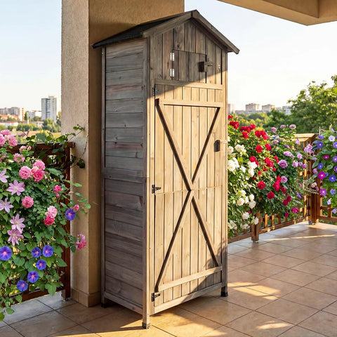 Tall Outdoor Wooden Storage Shed With Tall Vertical Tool Cabinet Folding Table And Removable Shelves For Your Patio Deck Backyard And Lawn Grey Finish 30x20x70 Inches against floral backdrop.