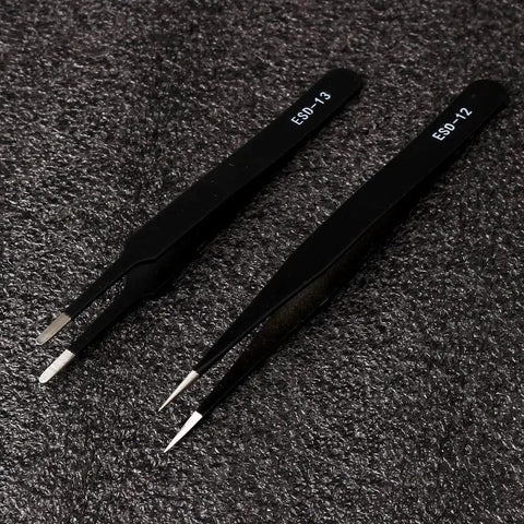 Pro Grade ESD Safe Tweezers Set, 2 of 7 Piece Stainless Steel Anti Static Precision Tweezers with Black Finish on textured surface.