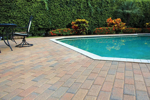 Premium Two Part Urethane Paver Sealer That Kicks Up Rich Outdoor Stone Color And Shields Concrete Patios With A Durable Semi Gloss Protective Finish That Goes The Distance applied on a patio near a pool.