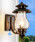 No Fuss Dusk To Dawn Sensor Outdoor Wall Sconce With Photocell, waterproof oil rubbed brown porch light on wall against blue sky.