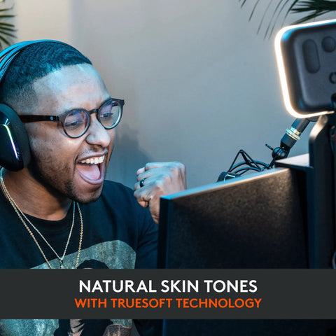 Person using Litra Glow Premium LED Streaming Light With TrueSoft Skin Tone For Crisp Video Calls at desk with headset and monitor.