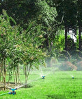 Rotating 360 Degree Lawn Sprinkler For Yard Coverage Up To 2000 Sq Ft With Auto Watering System in a garden setting