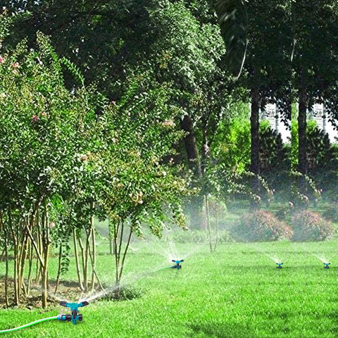 Rotating 360 Degree Lawn Sprinkler For Yard Coverage Up To 2000 Sq Ft With Auto Watering System in a garden setting