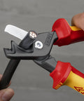 Close-up of StepCut XL Cable Shears 1000V Insulated 9 Inch cutting through wire, showing blades and red-yellow handles.