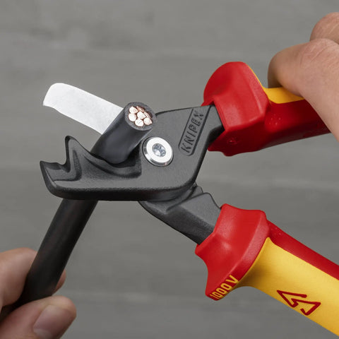 Close-up of StepCut XL Cable Shears 1000V Insulated 9 Inch cutting through wire, showing blades and red-yellow handles.