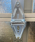 Two Eighteen Gauge Narrow Body Garage Door Hinges In Cold Rolled Steel With Galvanized Finish Replacement Hardware Installed on Door