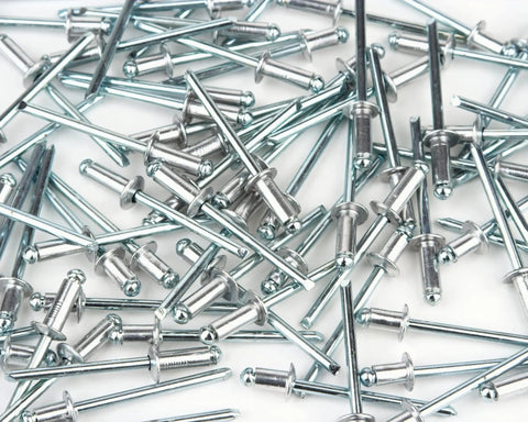 Top Shelf Aluminum Blind Pop Rivets Heavy Duty Fastener Pack Delivers Knockout Hold For Car Panels Garage Mods And Fence Repairs With 3/16 Inch Diameter And 1/8 Inch Grip Range Inside A Handy 100 Piece Tin Perfect For Any DIY Hustle Ready To Go, close-up of aluminum blind rivets.