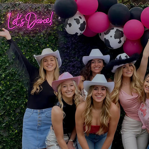 Group of women in cowboy hats under Let's Dance Neon Sign Pink LED Word Light for Weddings and Parties, Bar Decor.