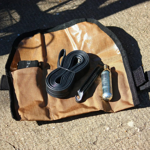 Blossom Roll Bike Saddle Bag with three tool pockets and repair kit, open with tools on tan Cordura fabric, for biking.