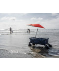 Versa Brella Firebrick Clamp On Shade Umbrella With UPF 50 Plus Protection attached to beach cart by the sea