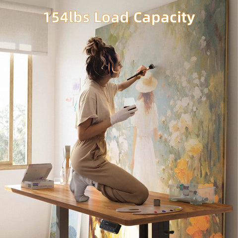 Yihayo Electric Standing Desk For Short People With 48 By 24 Inch Surface And Rustic Brown Finish. Artist using desk for painting.