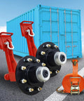 Two Pack Shipping Container Wheels With Eight Lug Configuration And Axle Ratchet Tie Down System For Moving Empty 20 To 40 Foot Marine Containers Marine Container Accessories Each Unit Certified To Support Up To 8800 Pounds shown with container in background.