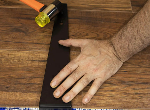 Using pull bar and rubber mallet from Professional Laminate Flooring Tools Kit With Tapping Block Pull Bar Rubber Mallet Knee Pads 45 Piece Pull Bar And 40 Piece Spacers For Vinyl Plank LVP And Hardwood Laminate Floors.