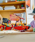 Child playing with Ninjago Destiny's Bounty Race Against Time 71797 Airship Battle Set With 6 Minifigures, 2 Dragons indoors