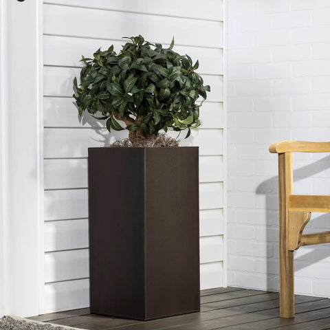 Badass Hammered Spray Paint In Sleek Dark Bronze Knocking Out Rust And Delivering All Weather Armor For Your Toughest Metal Wood Or Concrete DIY Builds That Never Quit on a tall planter with a leafy tree.