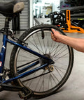 Using Interlocking Four-Piece Tire Lever Set For Road, MTB, Gravel And BMX Bikes to remove tire on floor bicycle.