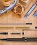 Colarr 20-pcs 7mm Slimline pen kit components with refill: dark wood pen body, brass tubes and black hardware on bench