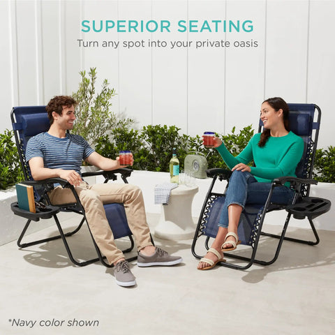 Two people sitting on Set Of 2 Adjustable Zero Gravity Lounge Chairs With Steel Mesh, Pillows, And Cup Holder Trays, Foldable And Portable
