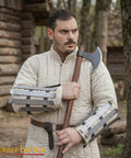 Man wearing Medieval Bracers For Cosplay And Reenactments, Fully Functional Arm Guards With Splinted Steel, holding an axe
