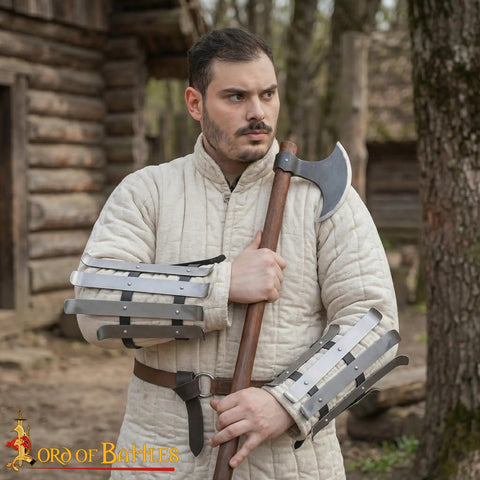 Man wearing Medieval Bracers For Cosplay And Reenactments, Fully Functional Arm Guards With Splinted Steel, holding an axe