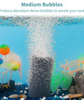 4 Inch Air Stone Cylinder For Larger Pumps Bubble Diffuser in aquarium creating medium bubbles, surrounded by colorful plants.