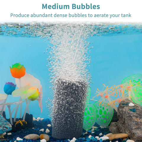4 Inch Air Stone Cylinder For Larger Pumps Bubble Diffuser in aquarium creating medium bubbles, surrounded by colorful plants.