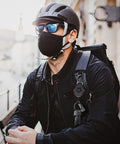 Person wearing backpack with Two Pack Retractable Keychains With Heavy Duty Carabiner Badge Holder clipped to strap