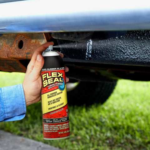 Hella Tough Rubber Sealant Spray Coating That Patches Roof Leaks Quick And Lays Down Flexible Waterproof Armor For Easy Whole House And Garage Fixes In A Six Pack Bundle in use under a vehicle.
