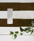 4 Pack Stainless Steel Mending Bracket Plates For Furniture Joints And Shelf Support on wooden background with leaf decoration