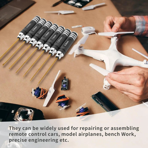Heavy Duty Pro Grade Titanium Coated Hex Screwdriver Kit With Seven Precision Steel Bits For Fpv Racing Drones Rc Helicopters And Watercraft Hassle Free Tuning Gear on a workspace with drone parts.