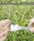 Close-up of the Ultra Lightweight Titanium Long Handle Spork With Polished Bowl For Camping And Hiking against grass background.